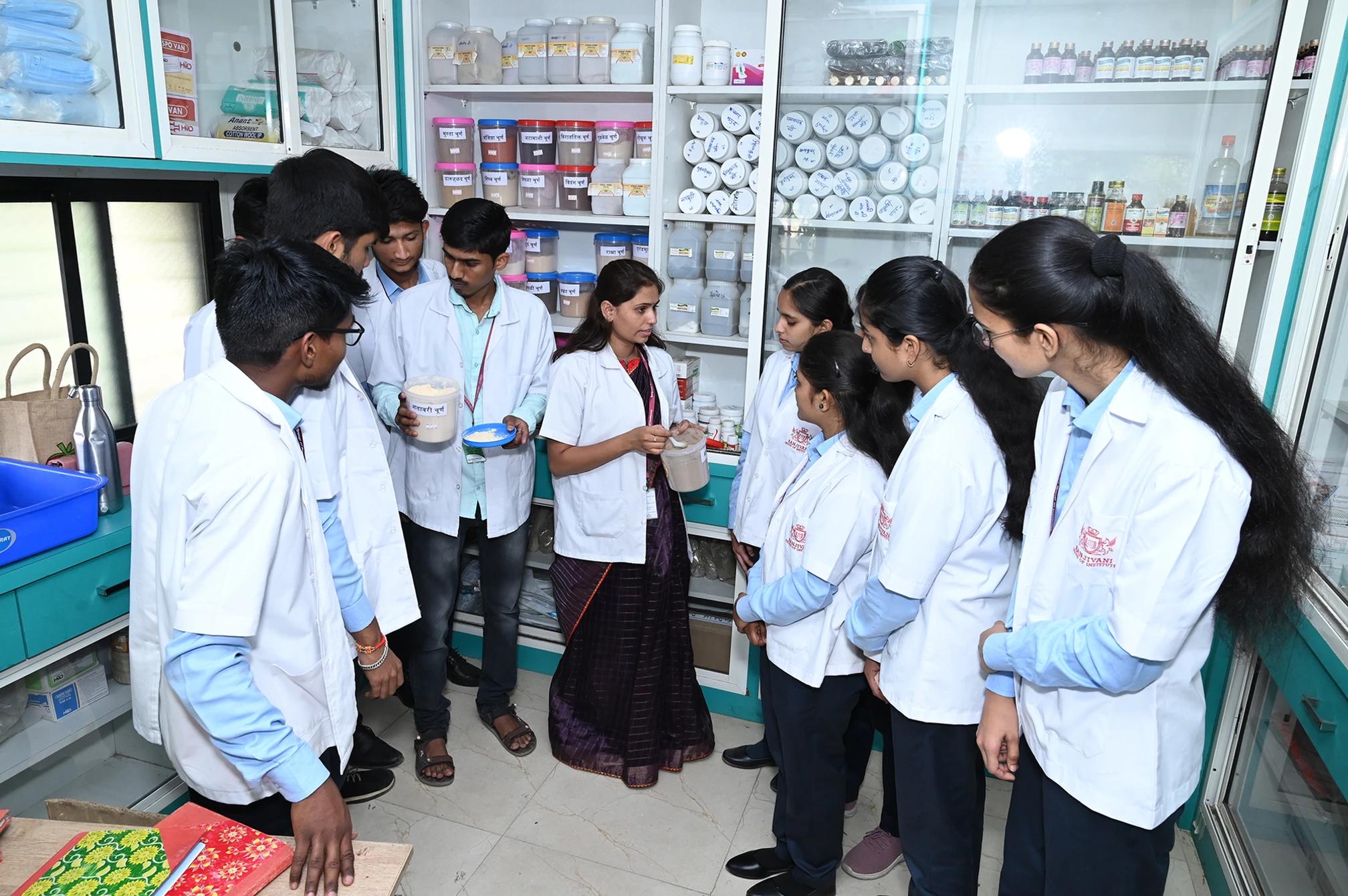 Students studying Ayurvedic medicines in a pharmacy laboratory