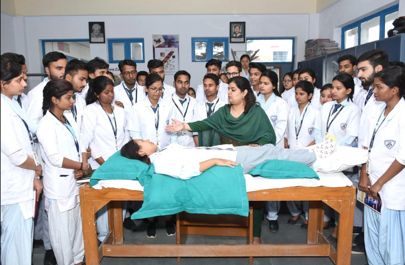 Faculty demonstrating a clinical procedure to Ayurvedic students